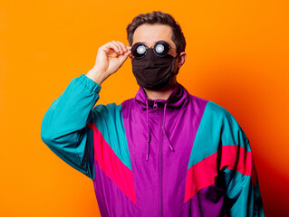 Style man in face mask, sunglasses and 80s tracksuit