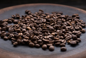 roasted aromatic coffee beans closeup sprinkled on a table