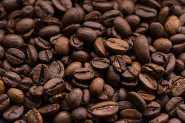 roasted aromatic coffee beans closeup sprinkled on a table