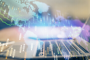 Financial graph colorful drawing and table with computer on background. Multi exposure. Concept of international markets.