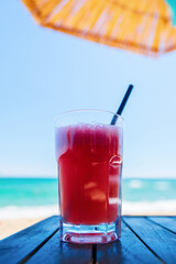 Fresh juice of watermelon in the background of the sea