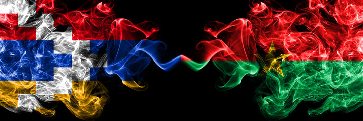 Nagorno-Karabakh, Artsakh vs Burkina Faso smoky mystic flags placed side by side. Thick colored silky abstract smoke flags