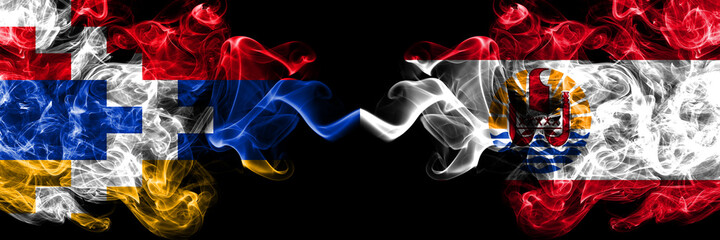 Nagorno-Karabakh, Artsakh vs French Polynesia smoky mystic flags placed side by side. Thick colored silky abstract smoke flags