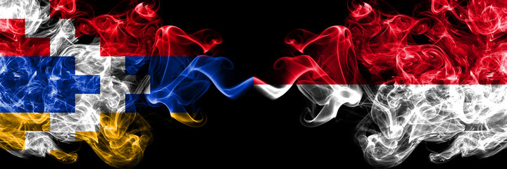 Nagorno-Karabakh, Artsakh vs Monaco, Monacan smoky mystic flags placed side by side. Thick colored silky abstract smoke flags