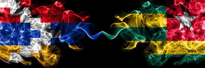 Nagorno-Karabakh, Artsakh vs Togo, Togolese smoky mystic flags placed side by side. Thick colored silky abstract smoke flags