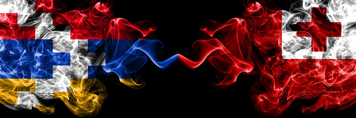 Nagorno-Karabakh, Artsakh vs Tonga, Tongan smoky mystic flags placed side by side. Thick colored silky abstract smoke flags