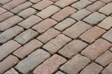 Foto op Aluminium Abstract background of old cobblestone pavement close-up. © yana_novak22