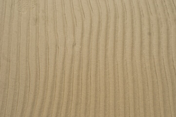 Fototapeta na wymiar Sand pattern texture, sand by the sea