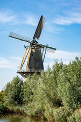 Fototapeta premium Flour windmill 'Nooit gedagt' on the waterfront of the fortified town of Woudrichem in summer in the Netherlands
