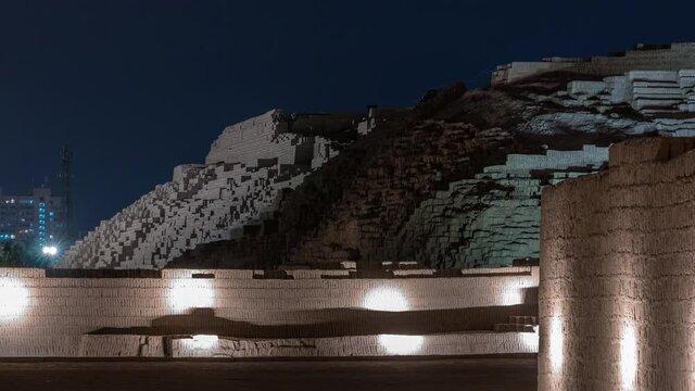Pyramid of Huaca Pucllana day to night transition timelapse, pre Inca culture ceremonial building ruins in Lima, Peru. Clouds on a sky. Illumination is turning on