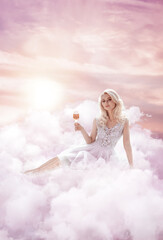 Beautiful woman in clouds in sunset
