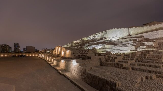 Pyramid of Huaca Pucllana day to night transition timelapse, pre Inca culture ceremonial building ruins in Lima, Peru. Clouds on a sky. Illumination is turning on