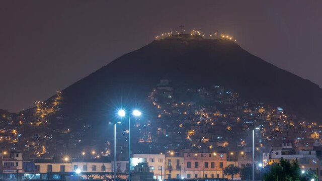 Slums on the slope of hill San Cristobal on the northern side of the river Rimac day to night timelapse. View from Muralla Park. Lima, Peru