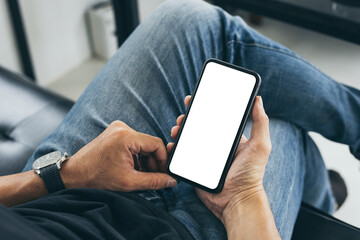 cell phone mockup blank white screen.man hand holding texting using mobile on desk at coffee shop.background empty space for advertise.work people contact marketing business,technology