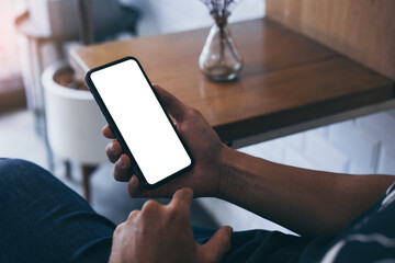 cell phone mockup blank white screen.man hand holding texting using mobile on desk at coffee shop.background empty space for advertise.work people contact marketing business,technology