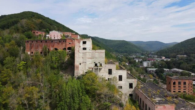View from above. Khrustalnensky mining and processing plant. The camera pans over the destroyed abandoned buildings of a mining factory in Russia