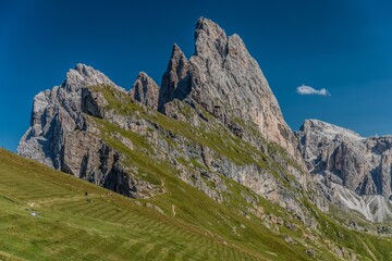 View of Seceda peak with little cute cloud, Santa Cristina Val Gardena, Dolomites, South Tyrol, Italy