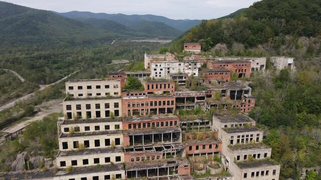 View from above. Khrustalnensky mining and processing plant. The camera pans over the destroyed abandoned buildings of a mining factory in Russia