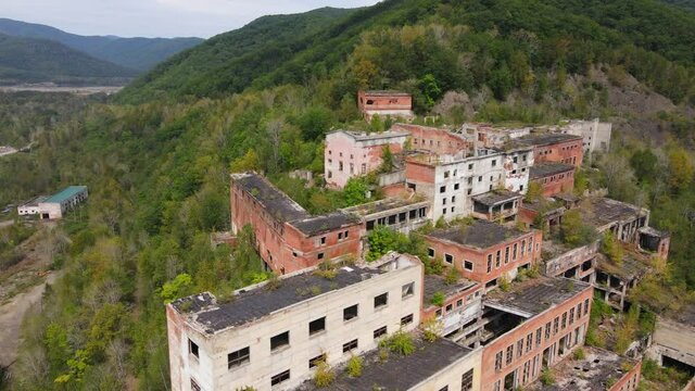 View from above. Khrustalnensky mining and processing plant. The camera pans over the destroyed abandoned buildings of a mining factory in Russia