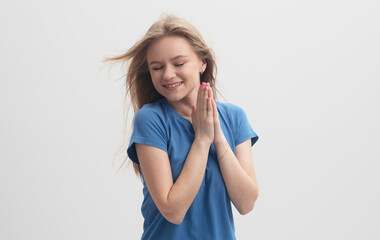 Cheerful young caucasian woman clapping hands isolated on a gray background with smile on face