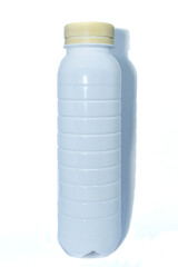 White plastic bottle with beige cap, isolated on white background. Realistic plastic bottle for liquids or dairy products. Plastic bottle template for milk or yogurt.