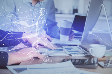 Start up drawings with businessman working on computer on background. Teamwork concept. Double...
