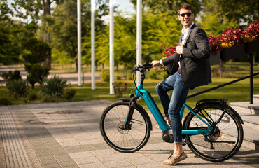 Plakat Young businessman on the ebike