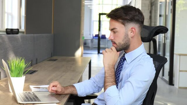 Serious businessman working check corporate business paper correspondence sitting on the desk in modern office.