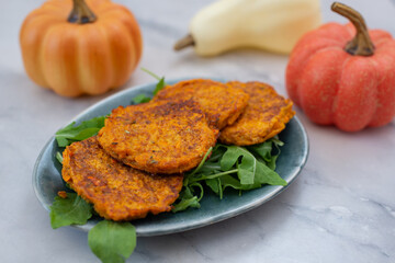 healthy home made pumkin patties with avocado and arugula salad