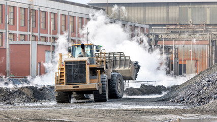 The big bulldozer and industrial pollution. Pollution is the introduction of contaminants into the...
