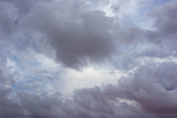 Naklejka na ściany i meble Grey purple high layered grey epic clouds on sky. Heaven cloudscape air view