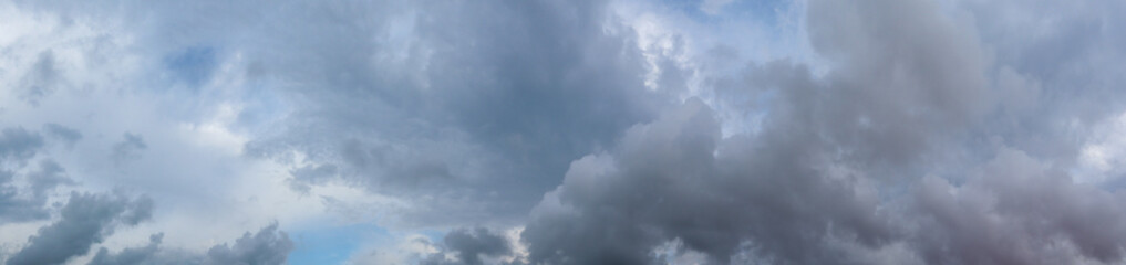 Fototapeta na wymiar Panorama of grey high layered grey epic clouds on sky. Heaven cloudscape air view