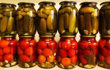 Pickled vegetables. Jars of pickled tomatoes and cucumbers
