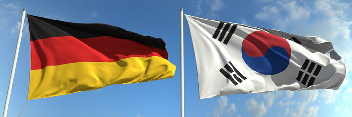 Flags of Germany and South Korea on flagpoles. 3d rendering