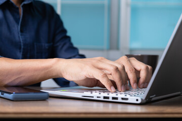 Fototapeta na wymiar Man's hands typing on laptop keyboard.
