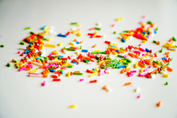 Selective focus colorful sugar sprinkle dots for decoration topping cake and ice cream on the table.