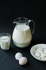 Different dairy products on the white wooden boards, blurred background