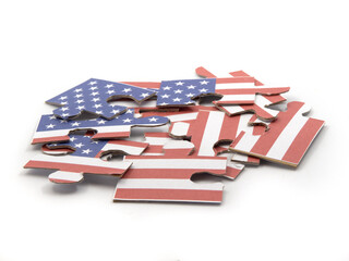 Jigsaw puzzle with picture of American flag in pieces in front of white background