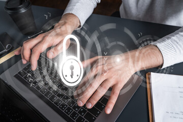 Man using computer. Hands typing laptop. Double exposure with lock icon hologram. Close up. Hacker security concept.
