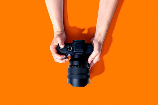 Person holding a SLR camera from above