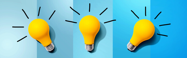 Three yellow light bulbs - flat lay from above