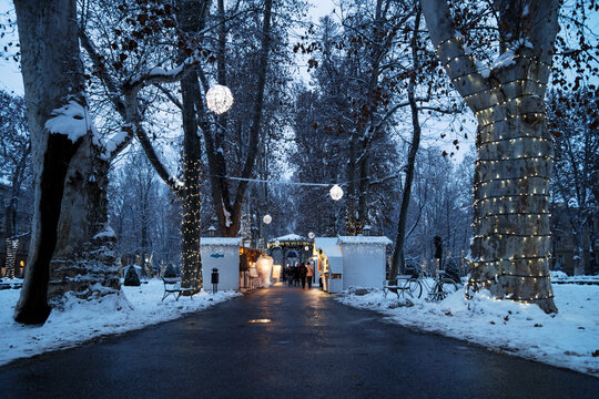 Advent market with foodstalls in the night with decoration lights with snow in Zrinjevac Park in Zagreb in winter, Croatia