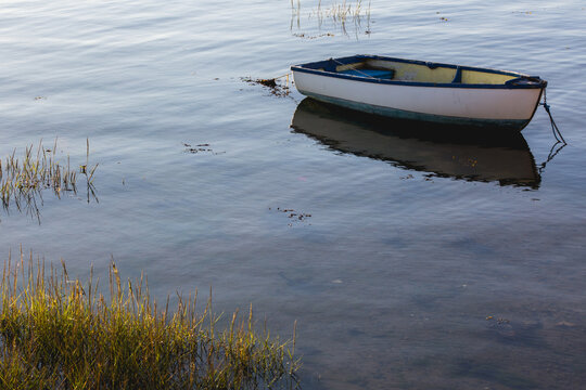 An old wooden boat moored in a calm marina
