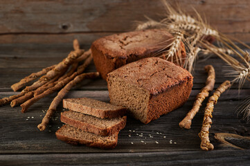 homemade rye bread with sesame seeds fresh baked aromatic on an old wooden table with grissini