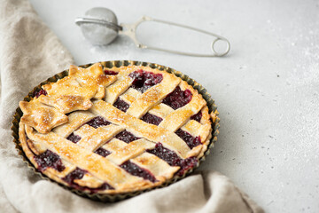 homemade raspberry pie made from crumbly dough on a white table