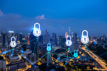 Glowing Padlock hologram, night panoramic city view of Kuala Lumpur, Malaysia, Asia. The concept of cyber security to protect KL companies. Double exposure.