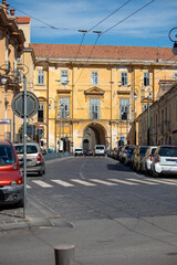 Fototapeta premium Naples, Italy. a street with cars, shops and traditional Italian architecture in central Napoli, Campania