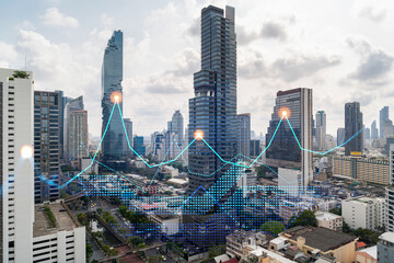 Financial stock chart hologram over panorama city view of Bangkok, business center in Asia. The concept of international transactions. Double exposure.