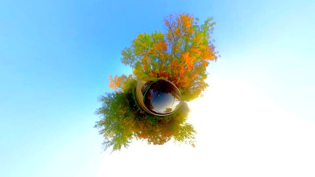 Fantastic tiny planet view of a Fall drive on country road, Autumn colors. 
