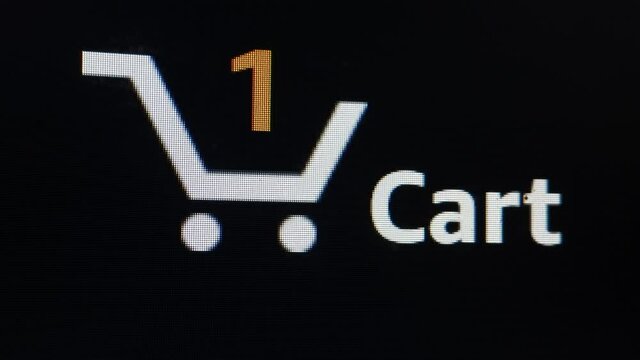 Close up shot of shopping cart icon on computer screen with  counting numbers add online commodity on shopping web page